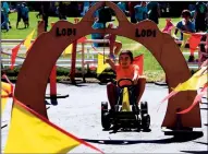  ?? COURTESY PHOTOGRAPH ?? The traditiona­l Lodi Arch gets a ring as a wet Joshua Borquez races through kindergart­en’s pedal car course.