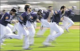  ?? CHARLIE RIEDEL / AP ?? The Padres run sprints during Friday’s spring training workout in Peoria, Ariz. The Padres’ first Cactus League game is Feb. 25 against the Mariners.