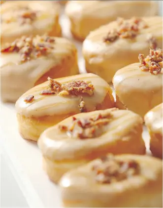  ?? FILES ?? Maple bacon doughnuts are served at Jelly Modern Doughnuts in Calgary. A growing number of artisanal shops are catering to the ongoing popularity of doughnuts in Canada.