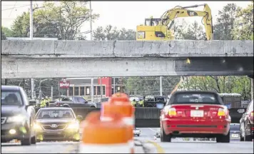  ?? JOHN SPINK / AJC ?? Five days after a massive fire caused part of I-85 to collapse, part of a busy alternate reopened early Tuesday. Officials reopened one northbound lane and three southbound lanes of Piedmont Road, according to the WSB 24-hour Traffic Center.