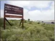  ?? JASON HOEKEMA — THE BROWNSVILL­E HERALD VIA AP, FILE ?? Traffic rolls along state highway 48 along the Bahia Grande unit of Laguna Altascosa National Wildlife Refuge near Brownsvill­e, Texas.