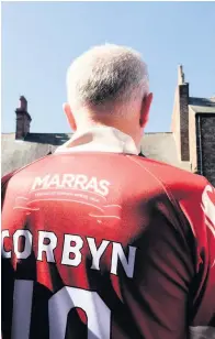  ??  ?? Labour Leader Jeremy Corbyn stands on the balcony of the County Hotel watching the parade at the Miner’s Gala on Saturday wearing his specially-made “Marras” shirt