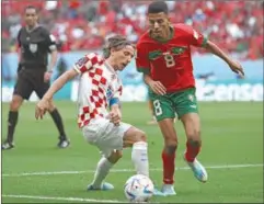  ?? (AFP) ?? Croatia’s midfielder Luka Modric (left) and Morocco’s midfielder Azzedine Ounahi fight for the ball during the Qatar 2022 World Cup Group F football match at the Al Bayt Stadium in Al Khor on Wednesday.