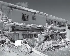  ?? PHOTOS BY PEDRO PORTAL pportal@miamiheral­d.com ?? View of the rubble of the Taco Maker restaurant, on the first floor of a destroyed commercial building in Guanica.