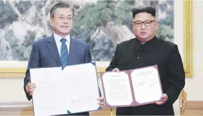  ?? Picture:EPA-EFE ?? THIRD SUMMIT. South Korean president Moon Jae-in, left, shows a document with North Korean leader Kim Jong-un after a signing ceremony in Pyongyang, North Korea, yesterday.