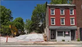  ?? Will Waldron / Times Union ?? The city said buildings at 397 and 399 South Pearl St. were actively collapsing, citing owners who were taken to court over multiple building code violations. An empty lot remains after an emergency demolition.