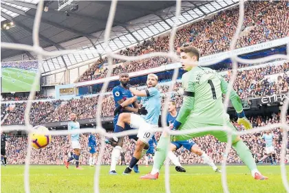  ?? Photo / Getty Images ?? Sergio Aguero scores the second of his three goals during yesterday’s 6-0 win over Chelsea.