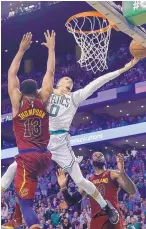  ?? CHARLES KRUPA/ASSOCIATED PRESS ?? Boston’s Jayson Tatum (0) drives to the basket as Cleveland’s Tristan Thompson (13) defends during the Celtics’ win over the Cavaliers Tuesday in Game 2.