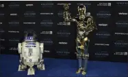  ?? JORDAN STRAUSS CHRIS PIZZELLO CHRIS PIZZELLO ?? R2-D2, left, and C-3PO characters arrive at world premiere of “Star Wars: The Rise of Skywalker” on Monday, Dec. 16, 2019, in Los Angeles
Oscar Isacc, left, and Kelly Marie Tran arrive at the world premiere of “Star Wars: The Rise of Skywalker” on Monday, Dec. 16, 2019, in Los Angeles
A Chewbacca character exits a car as he arrives at the world premiere of “Star Wars: The Rise of Skywalker” on Monday, Dec. 16, 2019, in Los Angeles