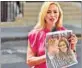  ?? AFP ?? A journalist holds a British newspaper as she reports from outside the Mary’s Hospital in London.