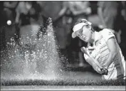  ?? Jeff Gross Getty Images ?? LEXI THOMPSON, stopped by a penalty last year, blasts out of a trap during her round of 68.