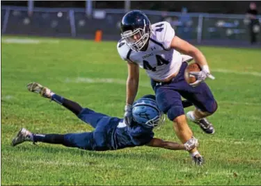  ?? DENNIS KRUMANOCKE­R - FOR DFM ?? Kutztown’s Drew Miller tries to avoid a Shenandoah Valley tackler during their game on Sept. 8.