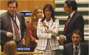  ?? (Mike Segar/Reuters) ?? US AMBASSADOR Nikki Haley (center) greets her Israeli counterpar­t Danny Danon at a United Nations General Assembly meeting in New York on Wednesday.