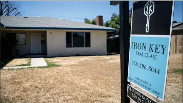  ?? LARRY VALENZUELA — CALMATTERS/CATCHLIGHT LOCAL ?? A real estate sign is seen in front of a home in the Tower District in central Fresno on June 28, 2022.