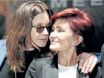  ?? ASSOCIATED PRESS FILES ?? Ozzy Osbourne, left, says his marriage to wife Sharon, right, is back on track after she kicked him out of their home after allegation­s that Ozzy was unfaithful.