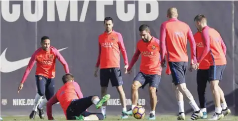  ?? —AP ?? SANT JOAN DESPI: FC Barcelona’s Arda Turan, center, controls the ball during a training session at the Sports Center FC Barcelona Joan Gamper in Sant Joan Despi, Spain, yesterday.