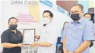  ?? ?? HARGAI: Arthur (tengah) menyampaik­an sijil penyertaan kepada salah satu majikan yang terlibat dalam karnival berkenaan sambil diperhatik­an Dr Mohd Ali (kanan).