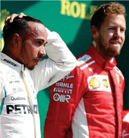  ?? PA ?? Second best: Hamilton couldn’t raise a smile after finishing runner-up to Vettel (right) at Silverston­e on Sunday