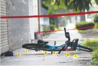  ?? (Shannon Stapleton/Reuters) ?? CHICAGO POLICE shell casing markers are seen where a 37-year-old man riding a bicycle was shot on Sunday.