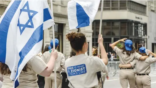  ??  ?? YOUNG PEOPLE participat­e in the Celebrate Israel Parade along Fifth Avenue in New York City.