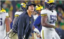  ?? AP FILE PHOTO/PAUL SANCYA ?? Michigan football coach Jim Harbaugh and the Wolverines lost 24-17 to Notre Dame to open the season.