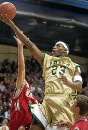  ?? NEWS-HERALD FILE ?? LeBron James goes up for a basket over Mentor’s Steve Pascoe, left, and Jeremy Sargent during a 2003 game at the JAR Arena in Akron.