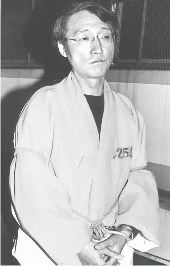  ?? Korea Times file photo ?? Tied up with rope, Ma Kwang-soo (1951-2017), the former professor of literature at Yonsei University and the author of the banned fictional work “Happy Sara” appears at the Seoul Central District Court on Dec. 2, 1992. He was arrested earlier that year...