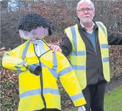  ??  ?? Councillor Dennis Melloy with the scarecrow officers in Coupar Angus.