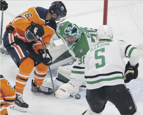  ?? PHOTOS: GREG SOUTHAM ?? Oilers forward Jujhar Khaira battles for a loose puck in front of Dallas Stars goaltender Ben Bishop during Thursday’s back-and-forth contest at Rogers Place, which the Oilers won 5-4 for only their second win on home ice this season.