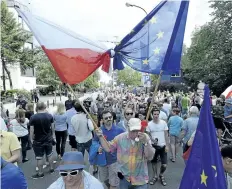  ?? CZAREK SOKOLOWSKI/THE ASSOCIATED PRESS ?? Government opponents protest in front of the parliament building in Warsaw, Poland, on Sunday, to protest the latest changes in legislatio­n that reorganize­d the judiciary.