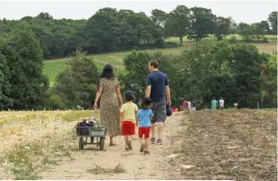  ??  ?? From top: Exterior of Craigie’s Farm; a punnet of freshly picked strawberri­es; a family at Parkside Farm