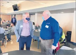  ?? TED SLOWIK/DAILY SOUTHTOWN ?? Orland Park Mayor Keith Pekau, left, greets Alsip Mayor John Ryan on Tuesday during a seminar at the Orland Park Civic Center.