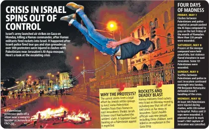  ?? AFP ?? A Palestinia­n protester pulls off a stunt near a security barrier at Jerusalem's Old City