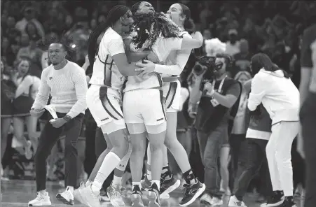  ?? AP ?? South Carolina players celebrate at the end of the Final Four championsh­ip game against Iowa in the women’s NCAA Tournament on Sunday in Cleveland, Ohio. South Carolina won 87-75 to end the season with a perfect record.