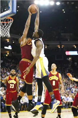  ?? — AFP photo ?? Draymond Green (R) of the Golden State Warriors has a shot blocked by Tristan Thompson of the Cleveland Cavaliers at ORACLE Arena on January 16, 2017 in Oakland, California.
