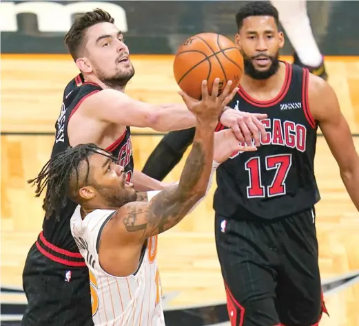  ?? JOHN RAOUX/AP ?? Bulls guard Tomas Satoransky defends against a shot by Magic guard Frank Mason III during the first half Saturday in Orlando, Fla.