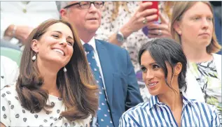  ??  ?? Kate and Meghan share a laugh in the royal box on Centre Court yesterday