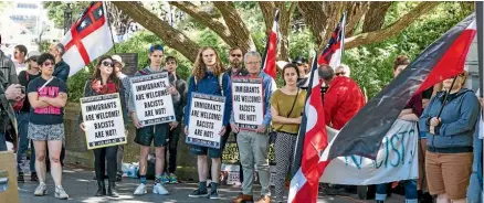  ??  ?? Protesters outside Parliament last year call for New Zealand to do more to make refugees welcome by increasing its quotas.