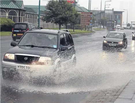  ??  ?? During one bout of heavy rainfall the water got quite deep for traffic travelling on Riverside Drive in Dundee.