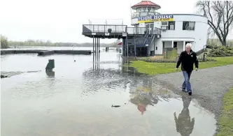  ?? CLIFFORD SKARSTEDT/EXAMINER ?? Marina manager Don Jackson observes flooding in Del Crary Park on Saturday. Area lakes could rise 10 centimetre­s, officials said Sunday.