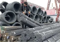  ?? AP ?? A worker loads steel products on to a vehicle at a steel market in Fuyang in central China’s Anhui province on March 2. The United States has extended tariffs on steel and aluminium to include trading allies Europe, Canada, and Mexico.