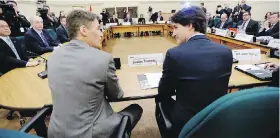  ?? SEAN KILPATRICK, THE CANADIAN PRESS ?? Prime Minister Justin Trudeau talks with Vancouver Mayor Gregor Robertson at a meeting of big-city mayors in Ottawa on Friday.