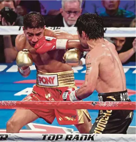  ??  ?? Manny Pacquiao (right) throws a right at Jessie Vargas in the 12th round of their WBO welterweig­ht championsh­ip fight on Sunday. Pacquiao won by unanimous decision.