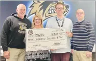  ?? Submitted Photo ?? Mitchael presents a check for $400 for the Bentonvill­e West High School choir program. Shown receiving the donation are Kayla Abernathy, BWHS choir director; Blaine Hill, associate choir director; and Guthrie.