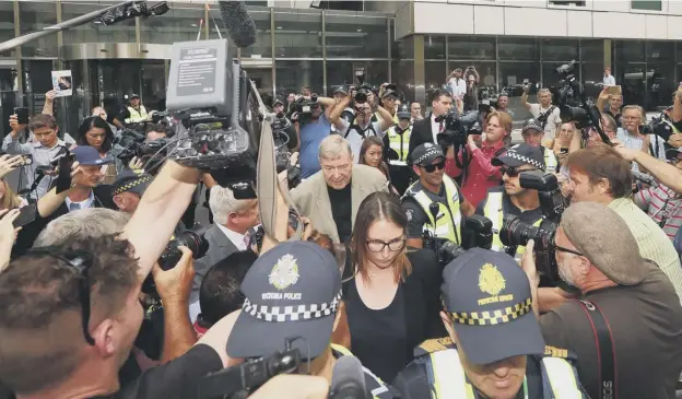  ?? PICTURE: MICHAEL DODGE ?? 0 A media scrum surrounded Cardinal George Pell as he left Melbourne’s County Court after the court lifted a publicatio­n ban on his guilty verdict