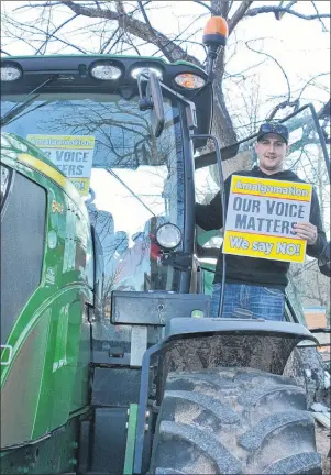  ?? COLIN MACLEAN/JOURNAL PIONEER ?? Patrick Walsh, a farmer from the Georgetown area, drove his tractor to the steps of the P.E.I. legislatur­e Tuesday for the Rally for Democracy, an event organized by a coalition of Islanders opposed to annexation and amalgamati­on in rural parts of the...