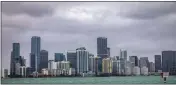  ?? PEDRO PORTAL/MIAMI HERALD — FOR THE ASSOCIATED PRESS ?? The Miami skyline is viewed from the Rickenback­er Causeway in South Florida last week. South Carolina and Florida are the two fastest-growing states in the country.