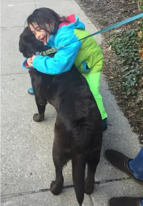  ?? ?? Alphonse the Labrador retriever was happy to be hugged anytime.