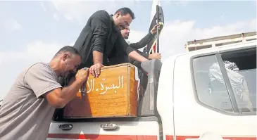  ?? REUTERS ?? An Iraqi man mourns over the coffin of a demonstrat­or during a funeral in Basra, Iraq yesterday.