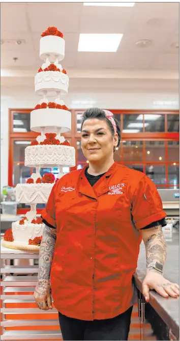  ?? @tylerramil­ls at Jmpforce ?? Christina Nasso, general manager of Carlo’s Bake Shop Las Vegas, made the replica of Elvis and Priscilla Presley’s 1967 wedding cake that will be on display Sunday at Caesars Palace as Las Vegas marks 70 years as the “wedding capital of the world.”